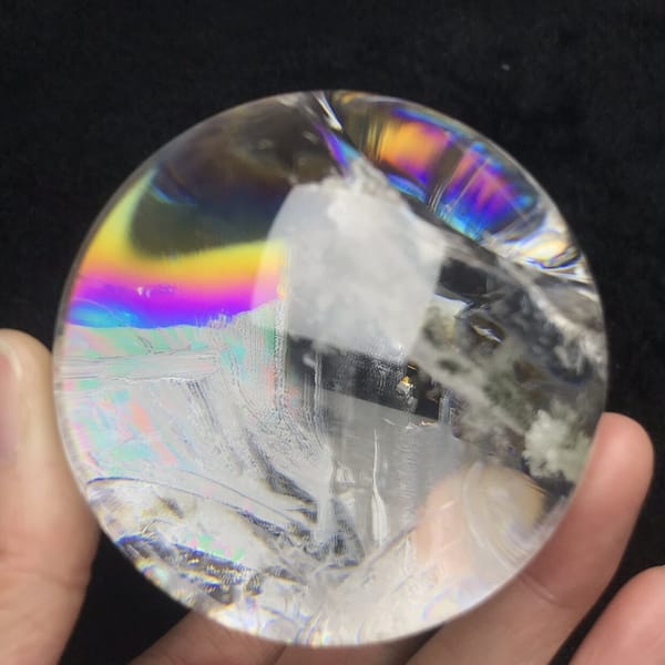 Wide rainbow across the top of the sphere above white phantoms