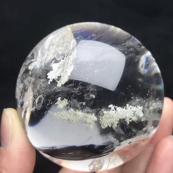 Clear sphere with white and green phantom clusters floating inside