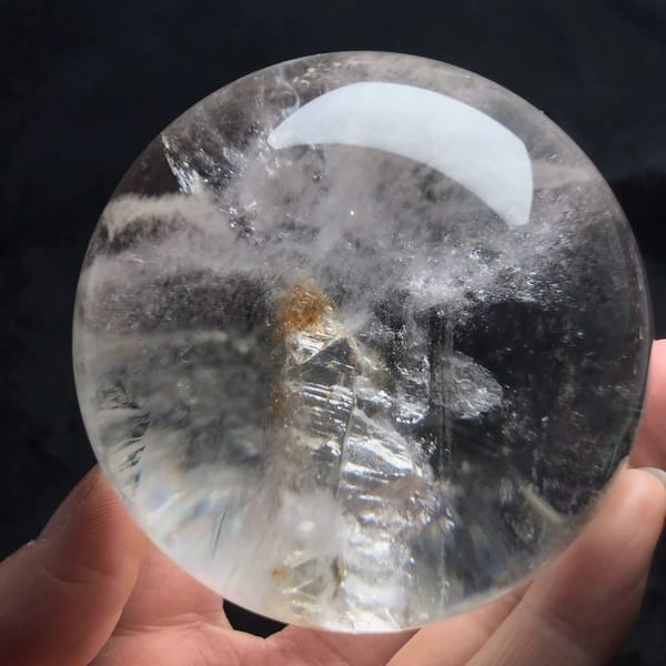 Upright skeletal crystal-in-crystal with a tan-brown tip inside clear quartz