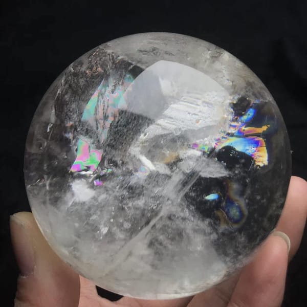 Rainbow wings on both sides of the white veils in the quartz