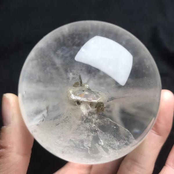 End view along the enclosed crystal, showing its pocket-like centre