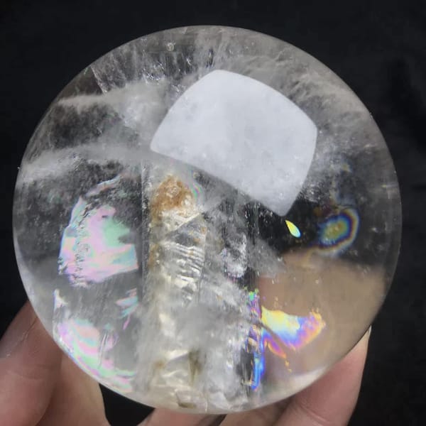 Skeletal crystal with rainbow patches on either side
