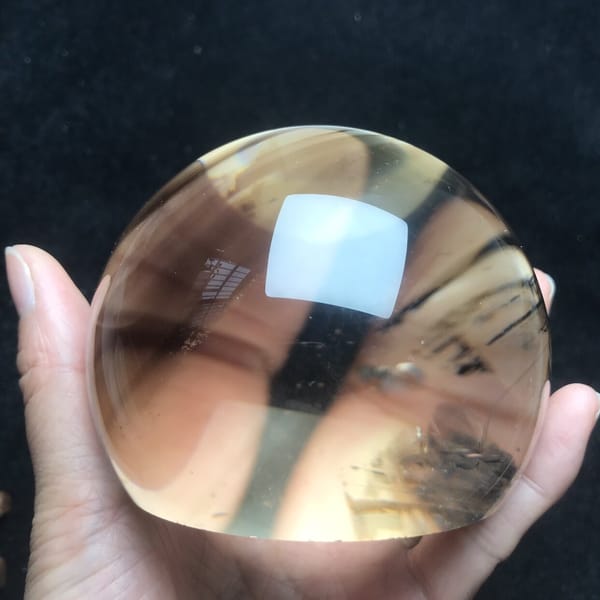 Smoky quartz dome with dark inclusions on the right side