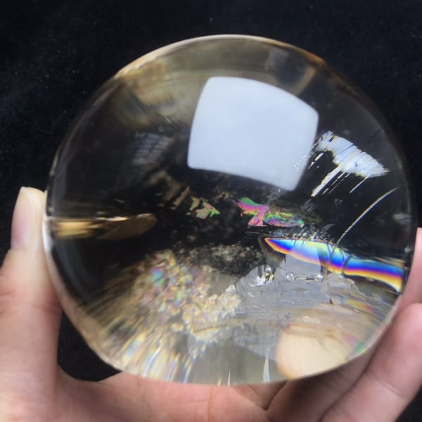 Rainbow and glittering white cluster in the clear smoky dome