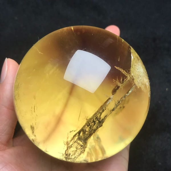 Honey-toned citrine with a long diagonal streak of white veils