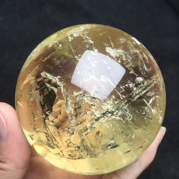Bright white crackle veils on the left of the golden citrine