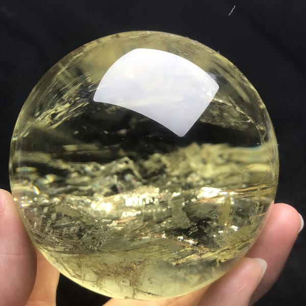 Horizontal layers of white inclusions like ice inside the citrine