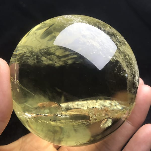 Golden citrine with a glinting plane under a clear top
