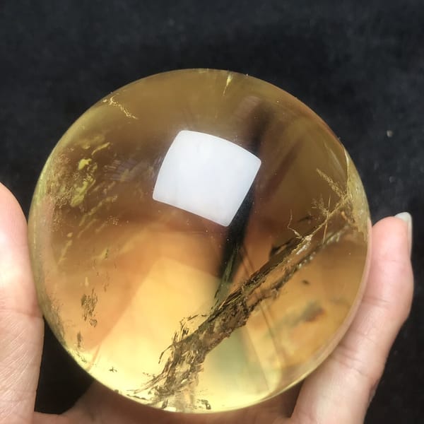 Amber-gold citrine with a diagonal veil from lower left
