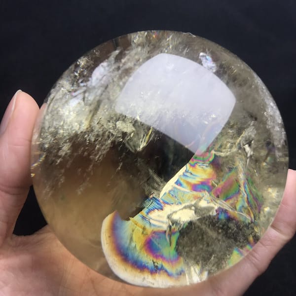 Fan-shaped rainbow beside frosty veils in the lower sphere