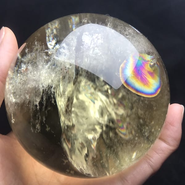 Bright rainbow disc and white veils on the citrine's left side