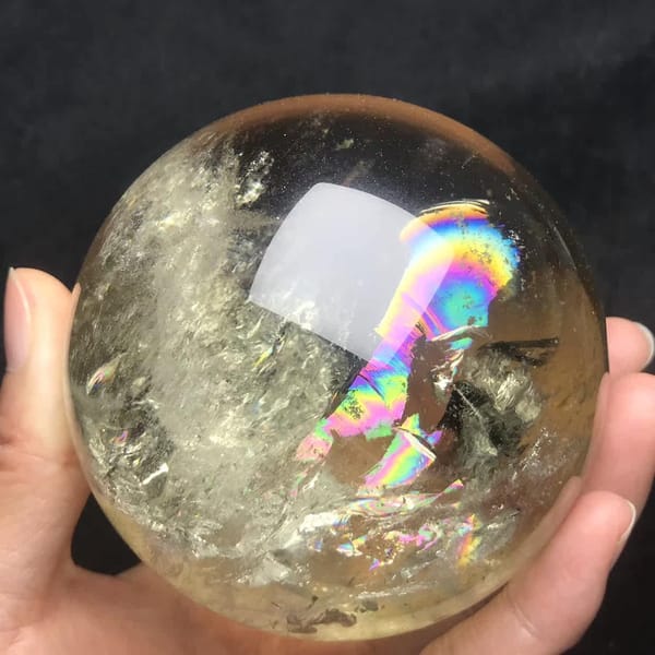 Rainbow curving under the light reflection of the sphere