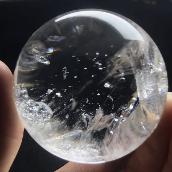 Tiny flakes and white feathers across the polished quartz