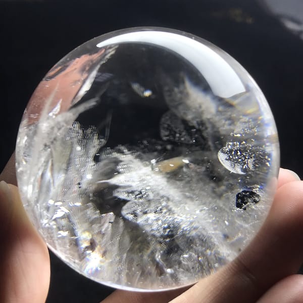 Black mica flake and white veil cluster on another side