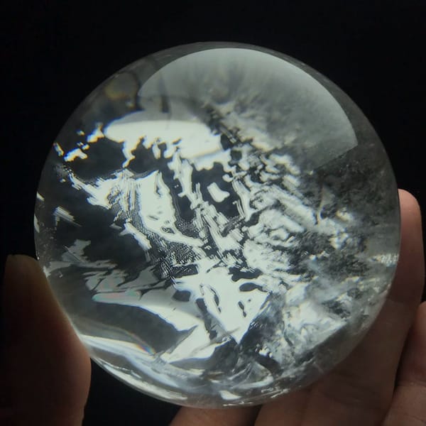 White inclusion sheets forming a snowy landscape pattern across the clear ball