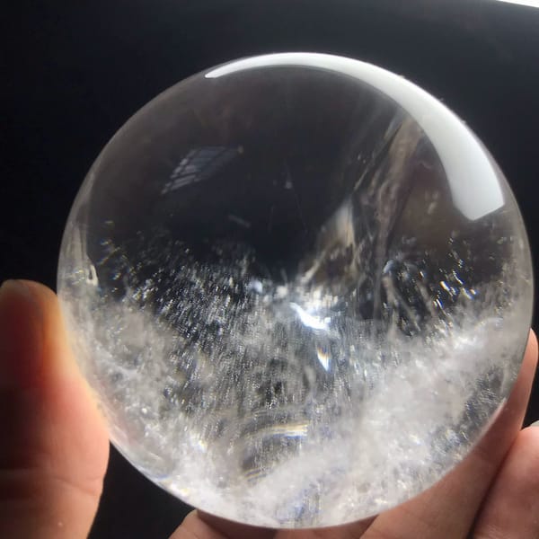 Clear upper half of the sphere above a frosty white band near the base