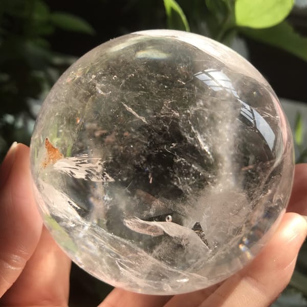 Front view of the enhydro sphere with white veils and the stained feather