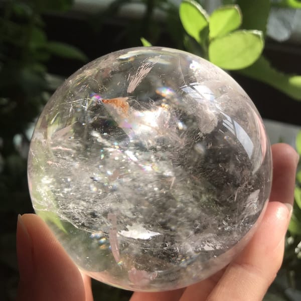 Glittering inclusion band across the middle of the clear quartz ball
