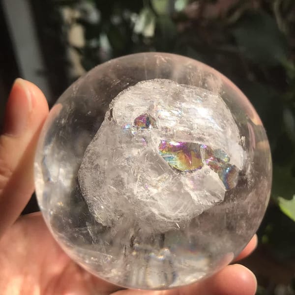 Frosted white zone with a rainbow flash inside the polished sphere