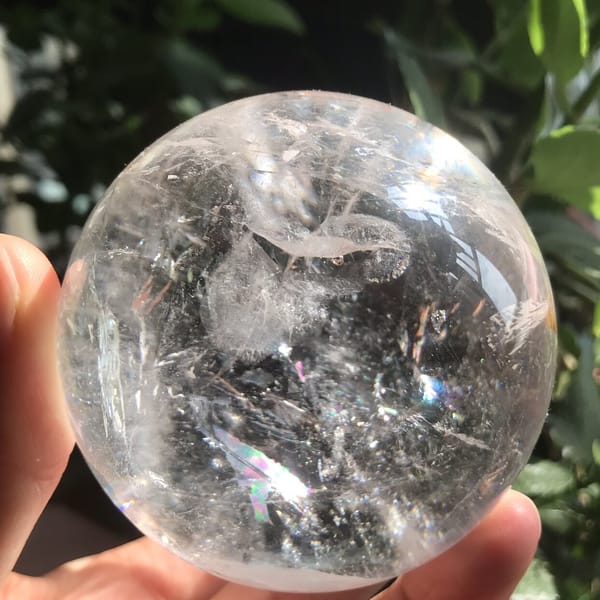 Curved white veils and fine needles in the lower half of the sphere