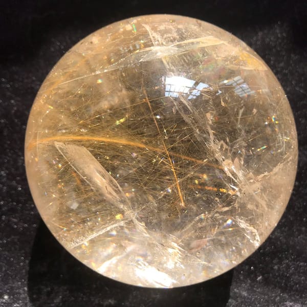 Thick golden rutile strands and a clear healed veil in the sphere