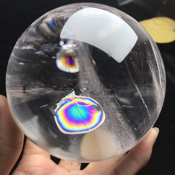 Rainbow disc with a violet centre and golden ring seen from below