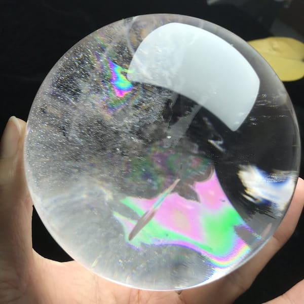 Pink and green rainbow sheet through misty inclusions in the quartz