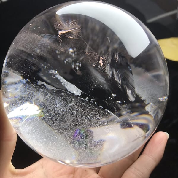 Glassy fracture plane and frosty veil viewed against a dark background