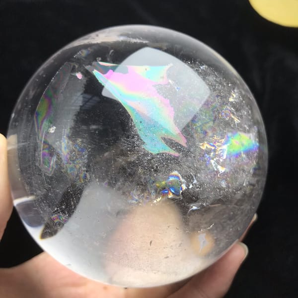 Pale blue and pink rainbow wedge near the top of the sphere