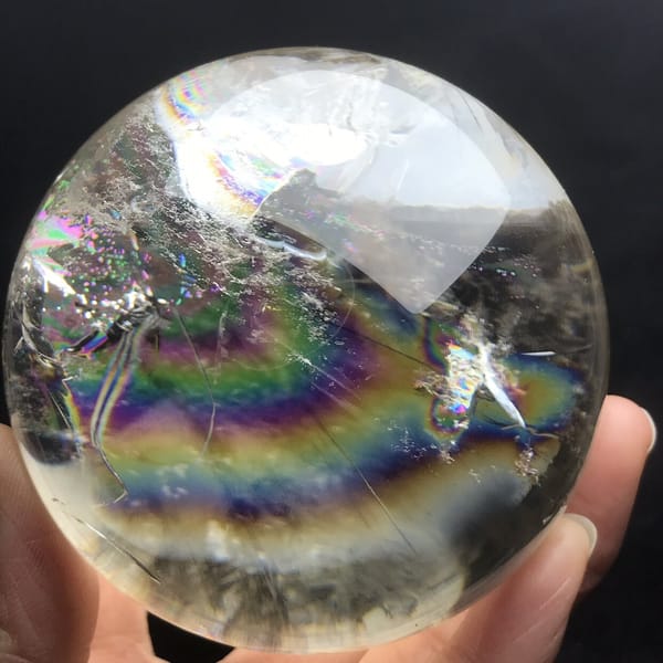 Wide rainbow below frosted white clouds at the top of the quartz