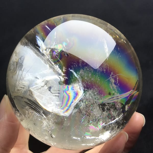 Arc of colour curving through clear quartz with veils on the left