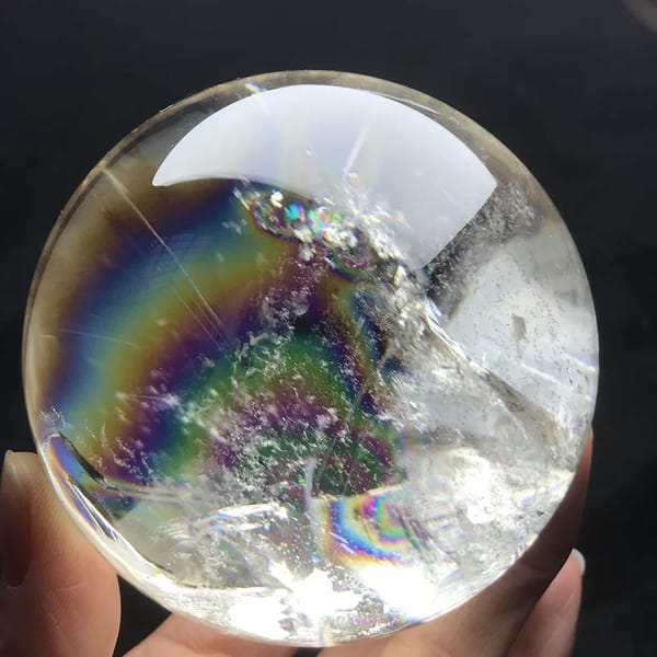 Rainbow wrapping the left side of the sphere under a polish highlight