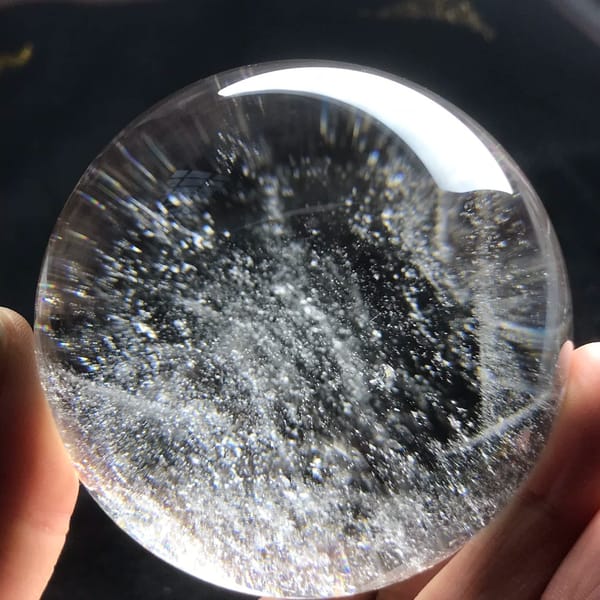 Dense snowflake-like inclusions drifting across the centre of the sphere