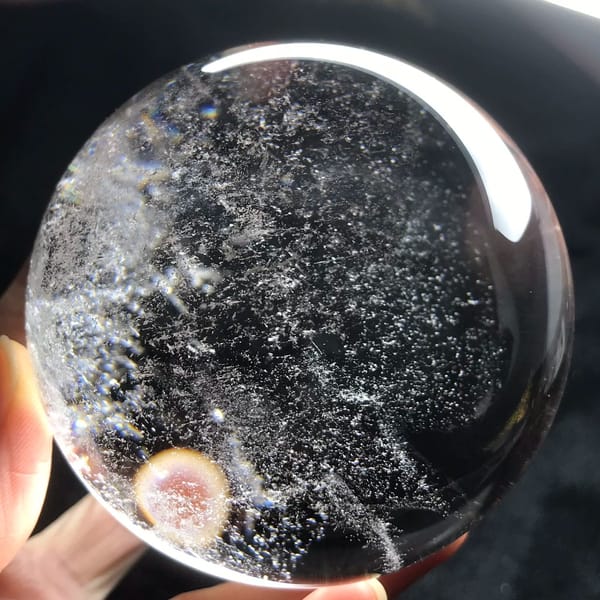 Snowy specks and a round pink hand reflection near the lower edge
