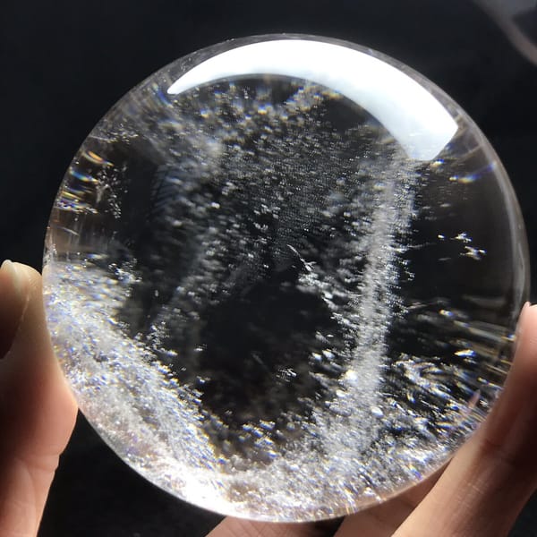 Vertical veil of white specks splitting the clear sphere in two