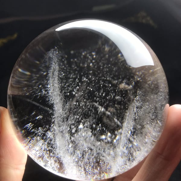 Twin white veils forming a V shape inside the clear quartz