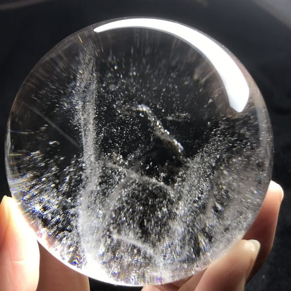 Curved veil lines and a small cloudy wisp in the clear sphere