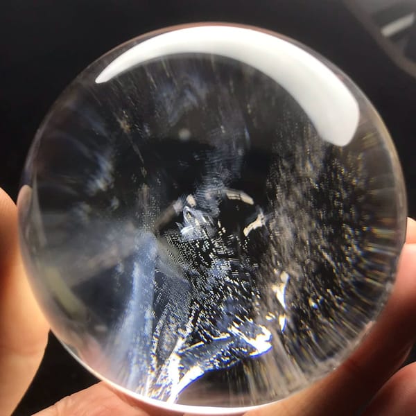 Dusty blue inclusion clouds and veils inside the clear Brazilian sphere
