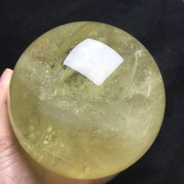 Soft white cloud band across the middle of the yellow sphere