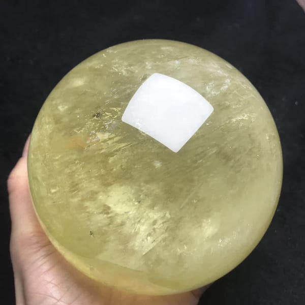 Warm yellow citrine sphere with scattered inner glints