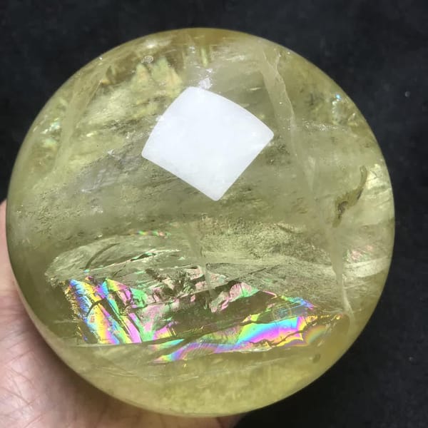 Rainbow plane low in the sphere beneath layered white veils