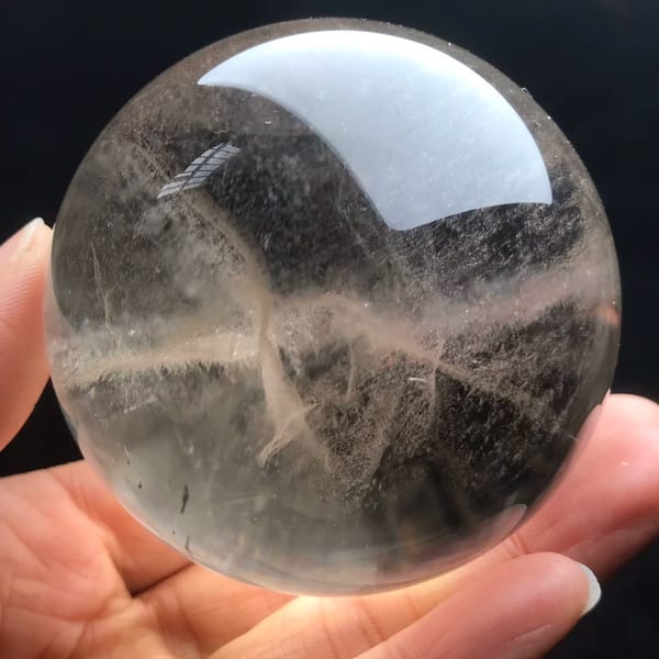 Wispy fibrous cloud at the centre of the pale smoky sphere