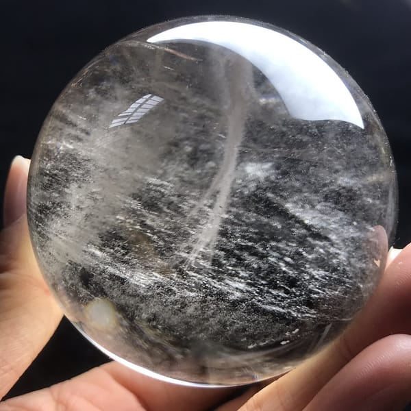 Darker smoky zone with streaky inclusions low in the sphere