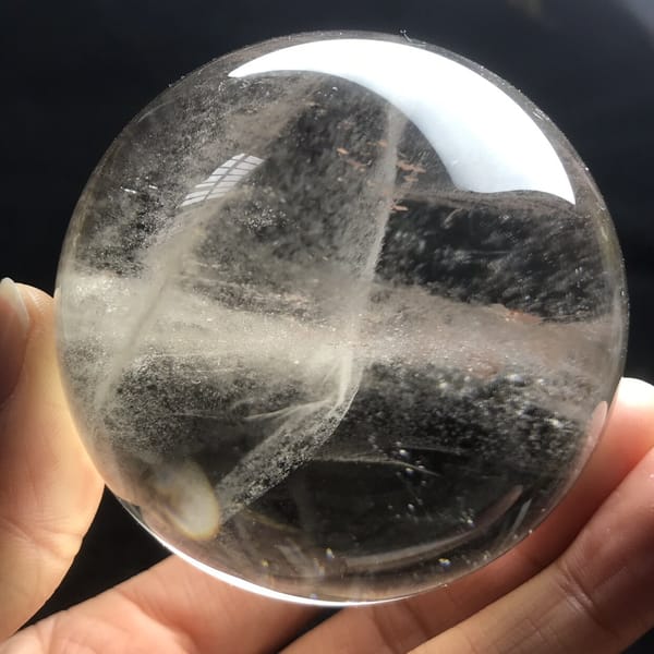 Smoky quartz sphere with crossed veils and a clear dome