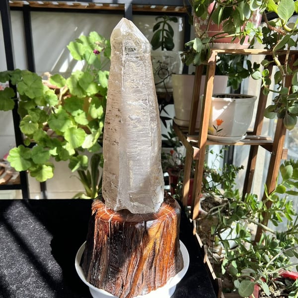 Laser quartz crystal on the stand with sunlight raking across its faces