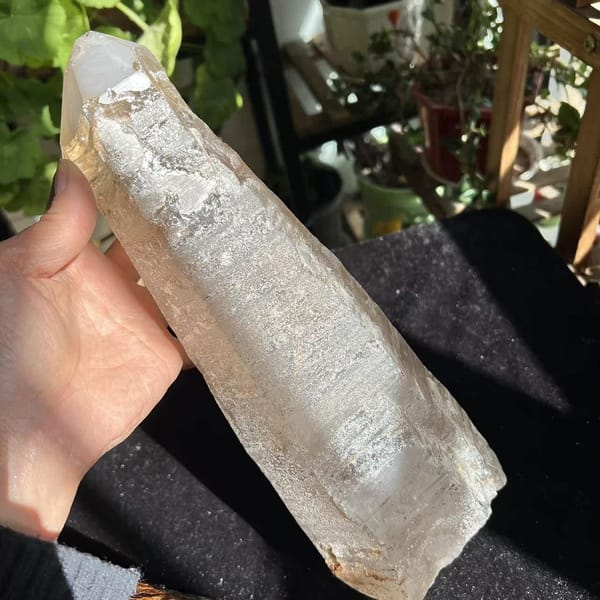 Hand holding the laser quartz to show the rough base and clear tip