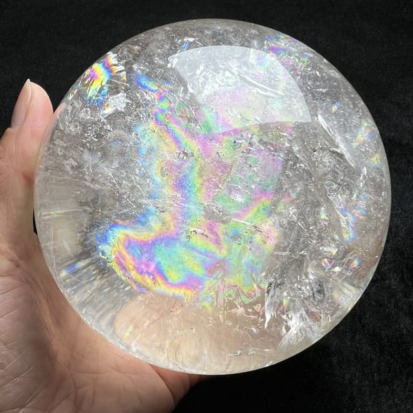 Pastel rainbow curling along the lower half of the clear sphere
