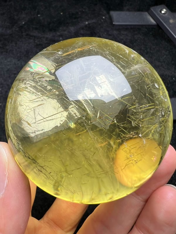 Citrine ball with criss-cross rune-like lines and a small rainbow glint