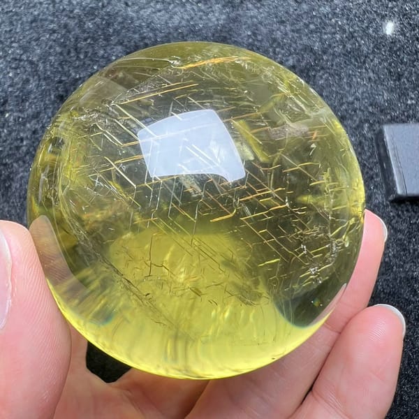 Angular rune-like markings visible across the face of the yellow ball