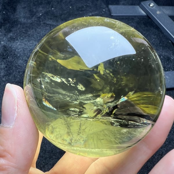 Citrine sphere angled to show darker honey-toned internal veils